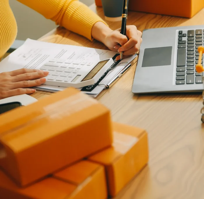 young-woman-small-business-owner-online-shopping-home-taking-note-orders-from-customers-with-mobile-phones-sme-entrepreneur-freelance-life-style-concept